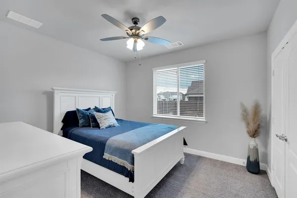 a bed room with a bed and a chandelier