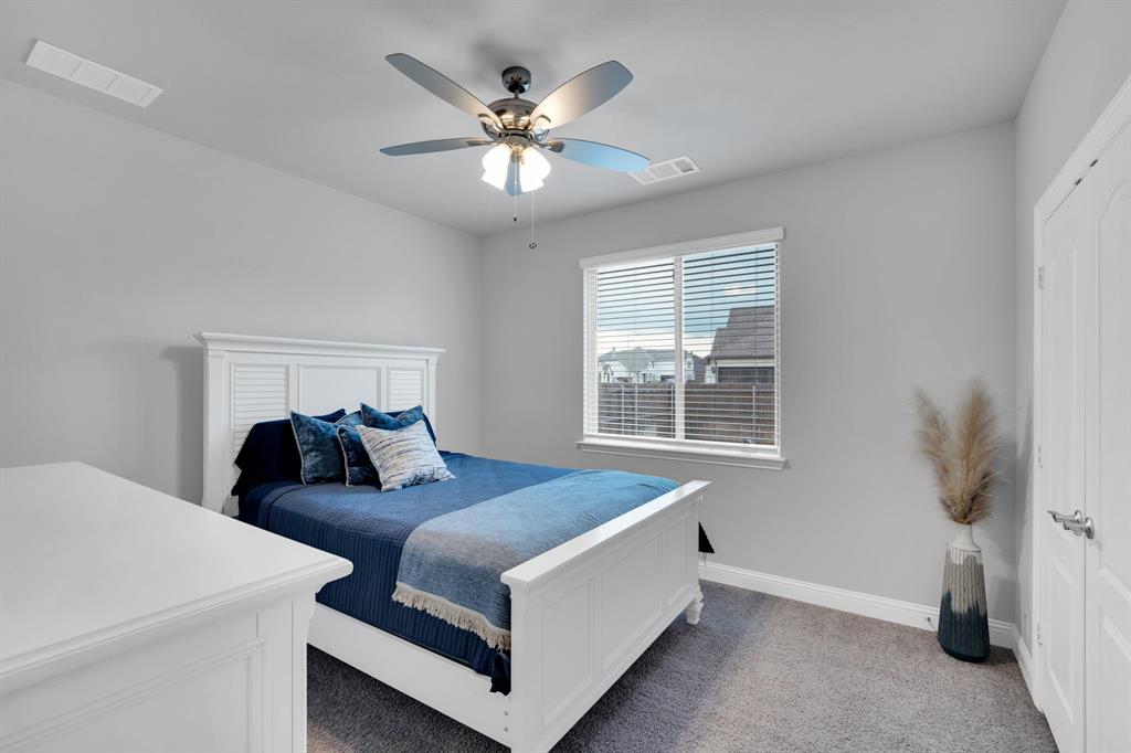 4605 Rambler Way Midlothian, TX 76065 - Photo 25 of 40 a bed room with a bed and a chandelier