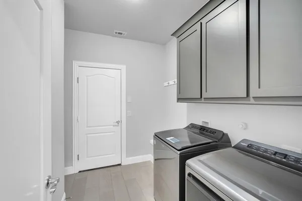 a view of a kitchen with white cabinets