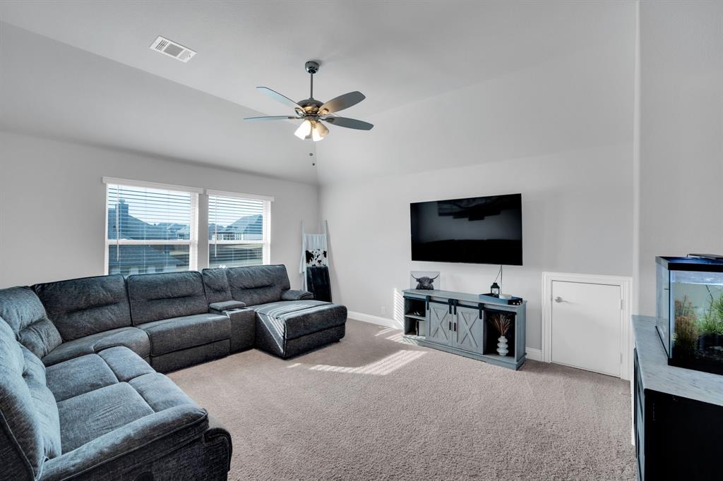 4605 Rambler Way Midlothian, TX 76065 - Photo 28 of 40 a living room with furniture and a flat screen tv