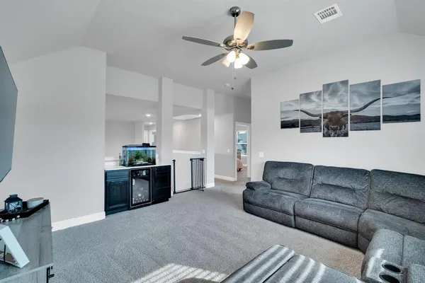 a living room with furniture and a chandelier