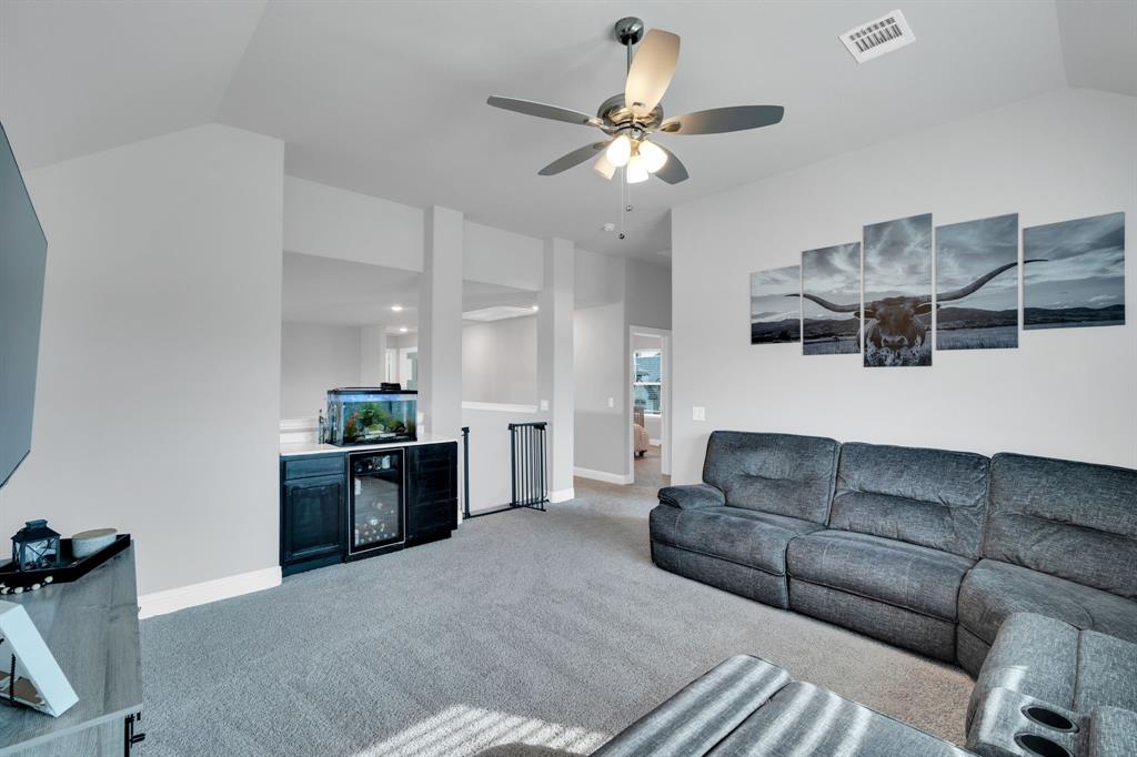 4605 Rambler Way Midlothian, TX 76065 - Photo 29 of 40 a living room with furniture and a chandelier