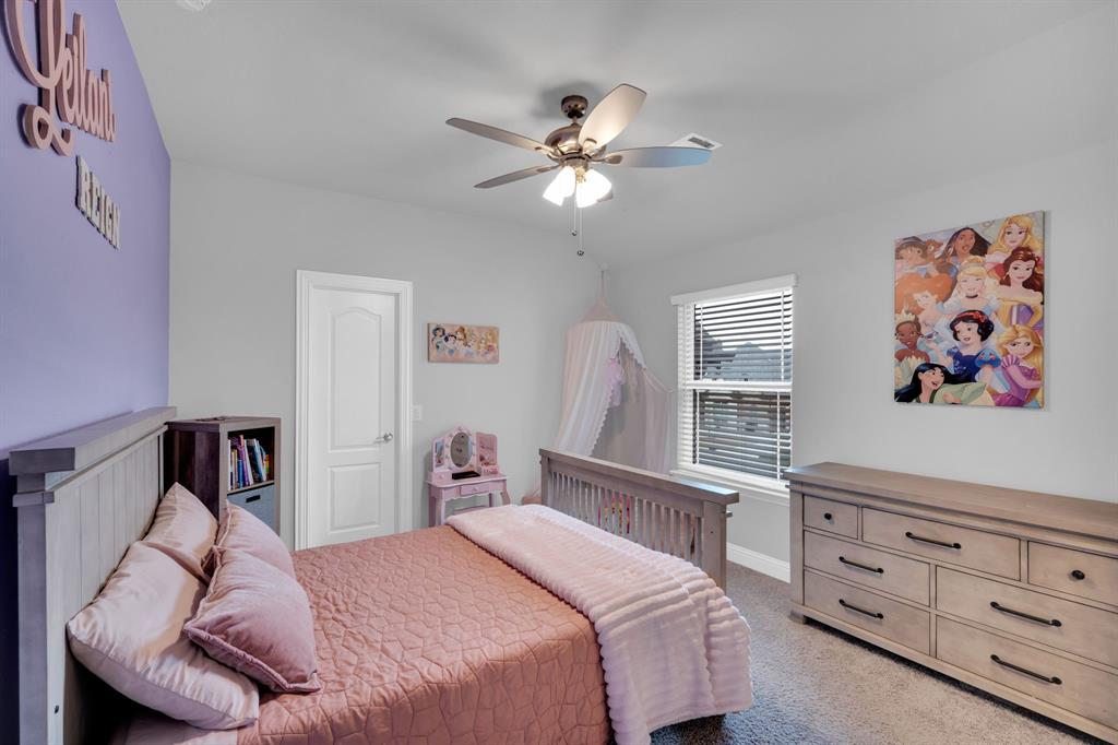 4605 Rambler Way Midlothian, TX 76065 - Photo 30 of 40 a bedroom with a bed and a chandelier