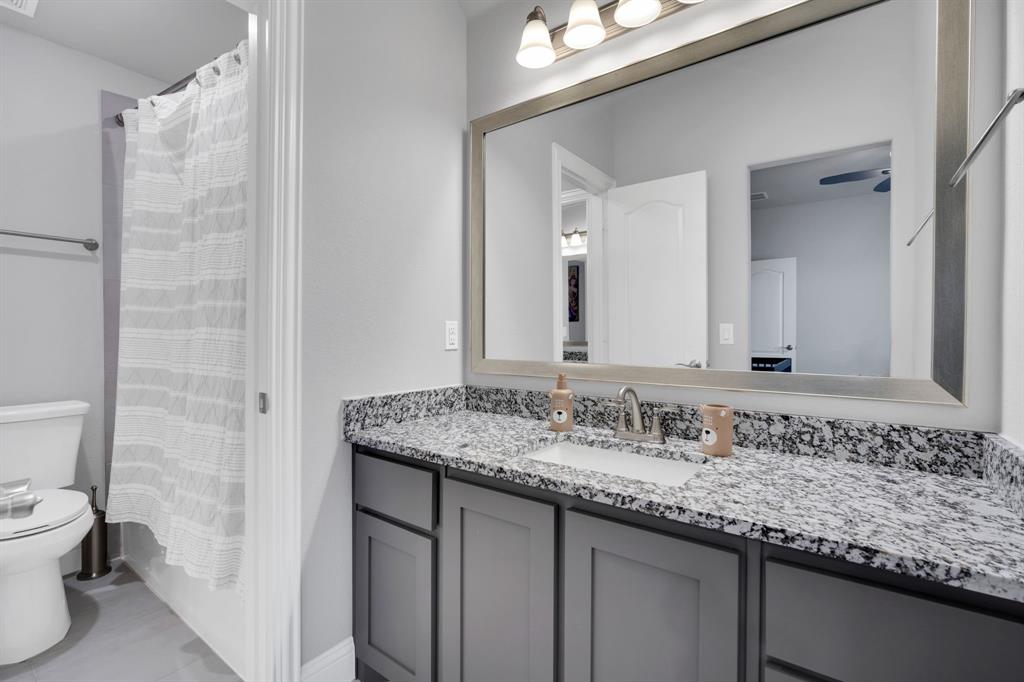 4605 Rambler Way Midlothian, TX 76065 - Photo 31 of 40 a bathroom with a granite countertop sink and a mirror