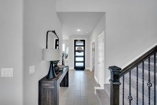 a view of a room with wooden floor and stairs