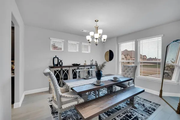a living room with furniture a table and chairs