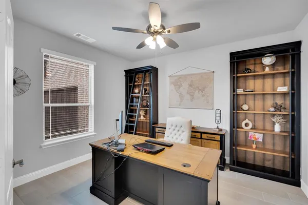 a view of a workspace with furniture and a window
