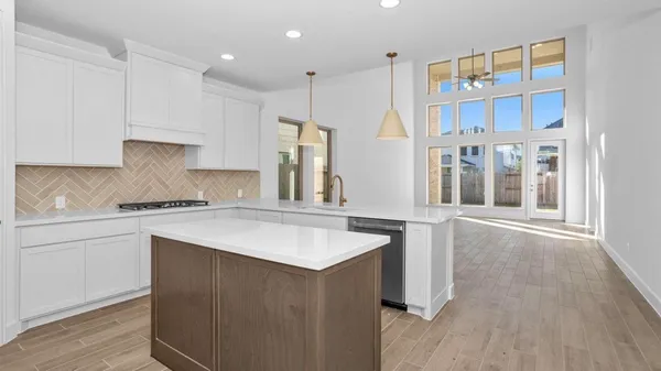 a kitchen with a sink stove and cabinets
