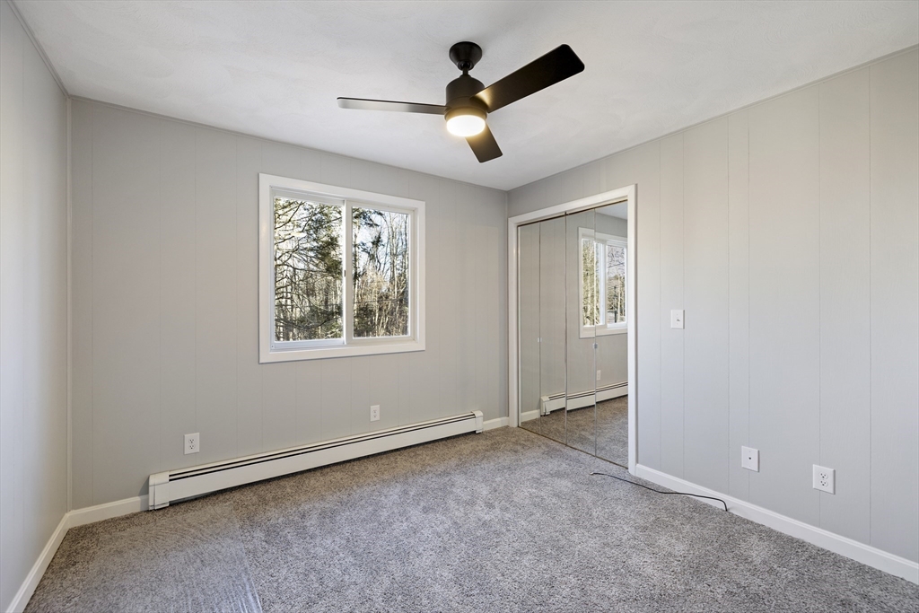 28 Long Hill Road Brookfield, MA 01506 - Photo 13 of 37 an empty room with ceiling fan and window