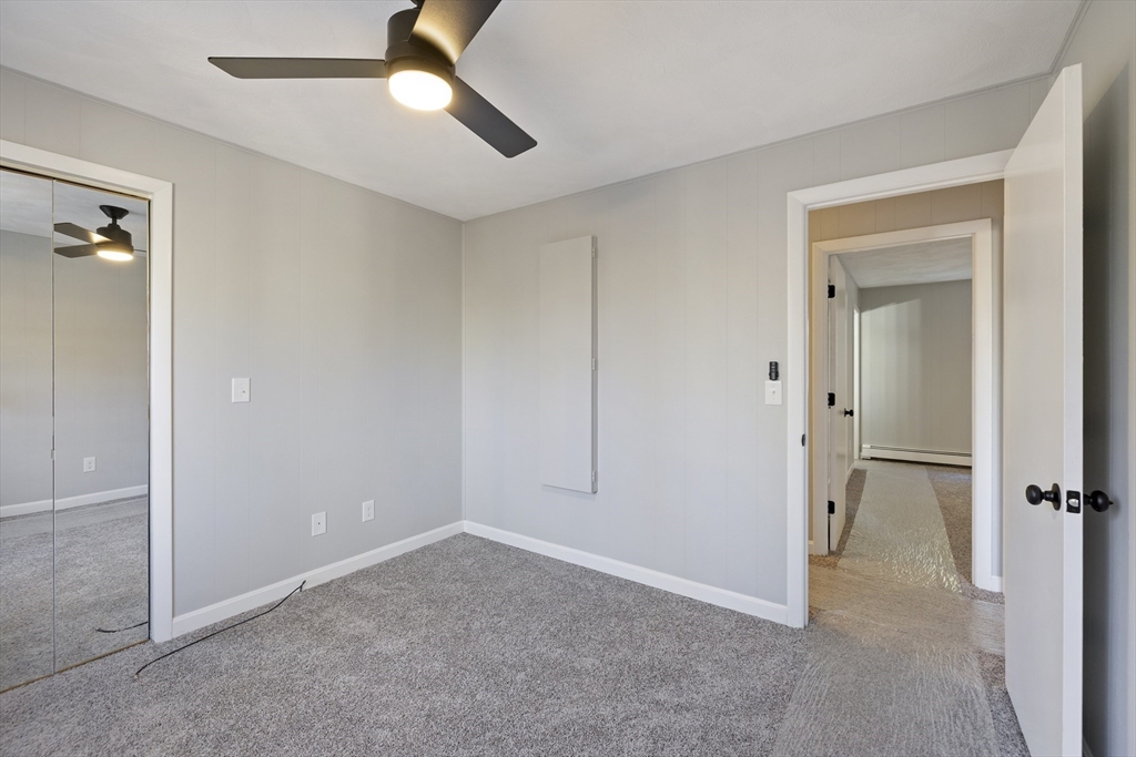 28 Long Hill Road Brookfield, MA 01506 - Photo 17 of 40 an empty room with closet and a chandelier fan
