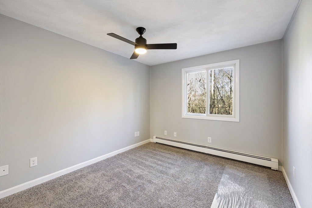 28 Long Hill Road Brookfield, MA 01506 - Photo 18 of 40 an empty room with a window and a ceiling fan
