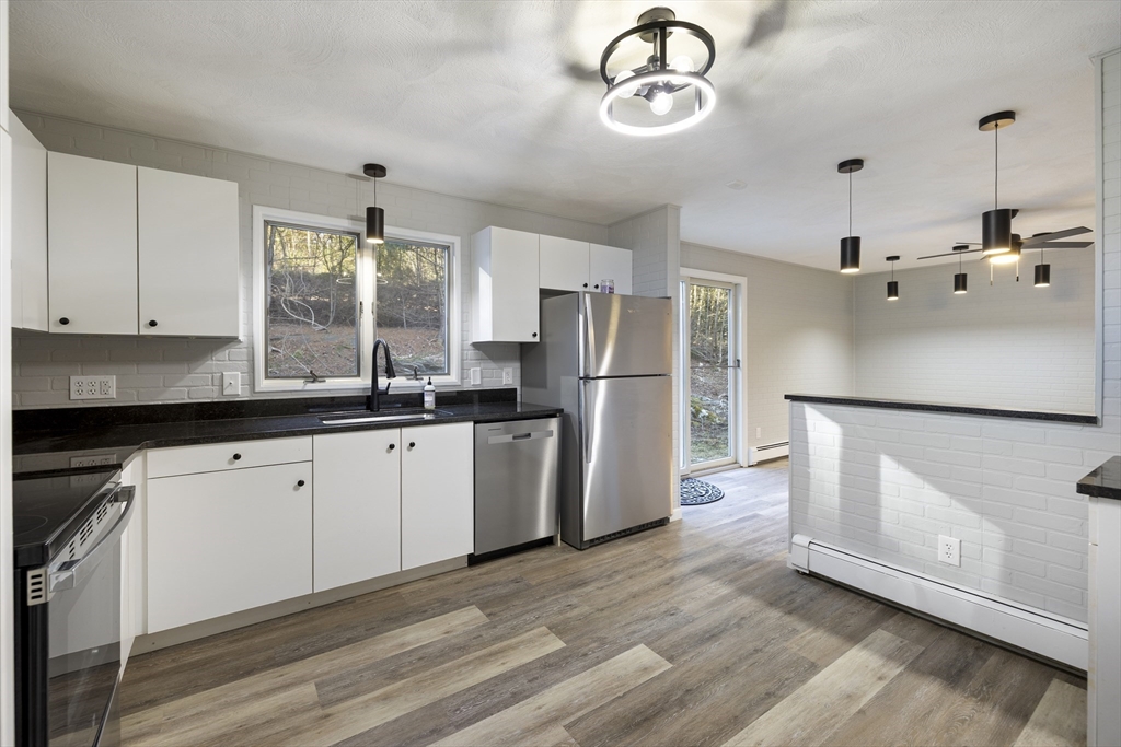 28 Long Hill Road Brookfield, MA 01506 - Photo 3 of 40 a kitchen with refrigerator cabinets and wooden floor