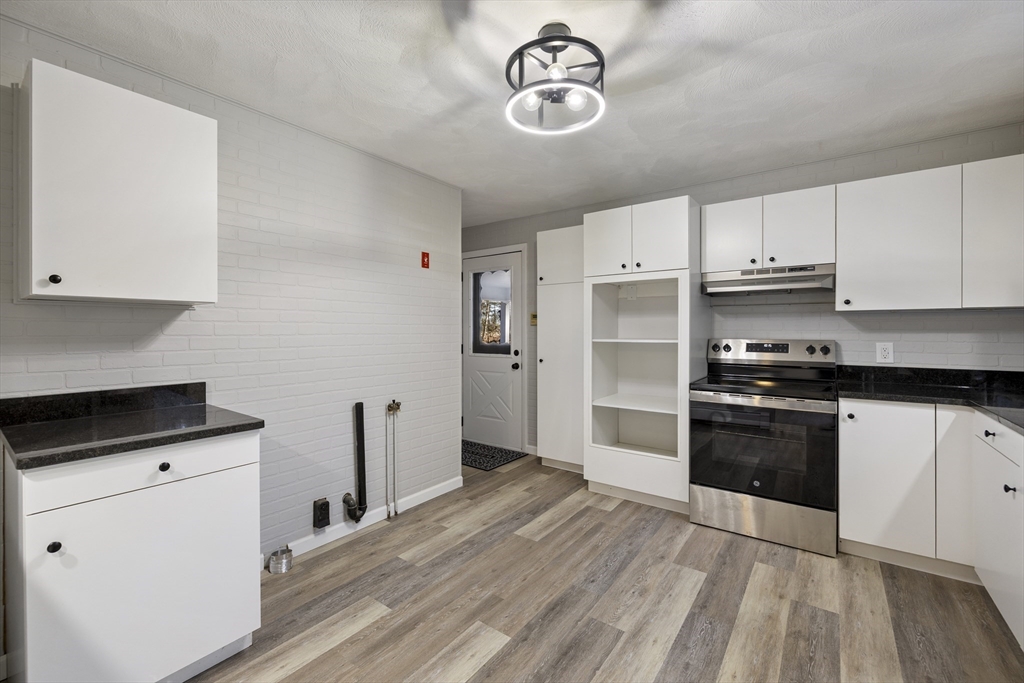 28 Long Hill Road Brookfield, MA 01506 - Photo 6 of 40 a kitchen with a refrigerator and a stove top oven