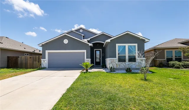 a front view of a house with a yard and porch