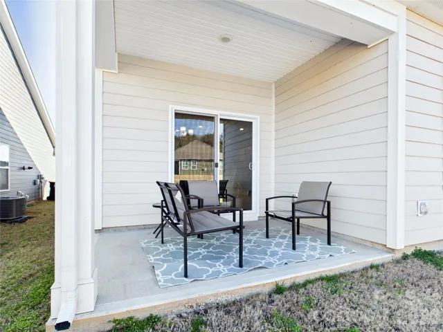 a view of dining room and chairs and table in a patio