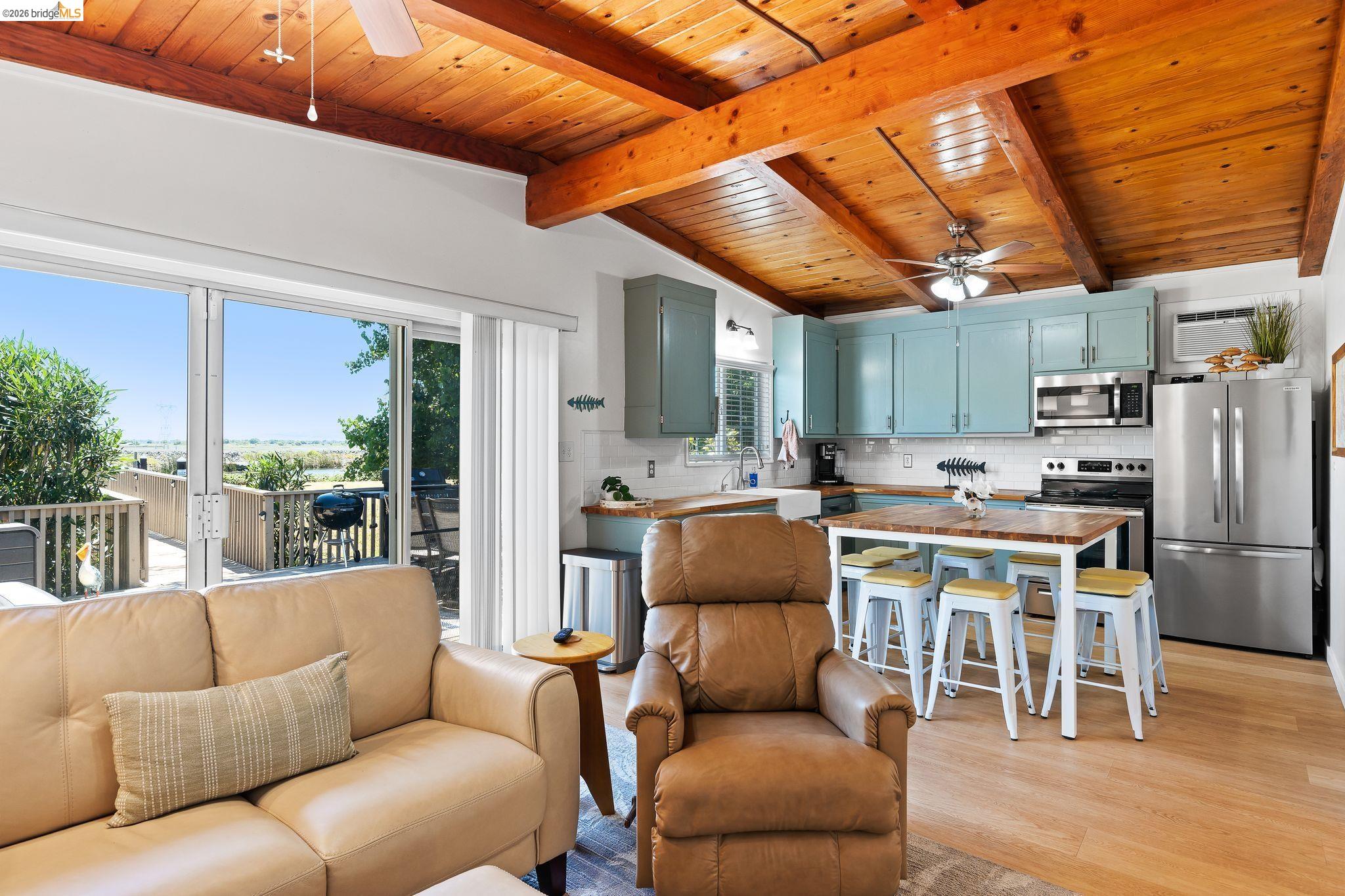 1704 Taylor Road Bethel Island, CA 94511 - Photo 25 of 73 Open-concept living space featuring wood-finish flooring, exposed beam ceiling, and a ceiling fan