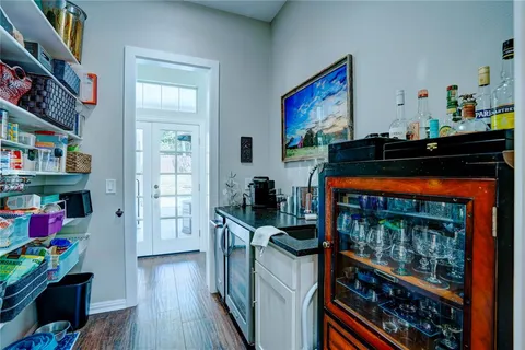 a view of a workspace with furniture and wooden floor