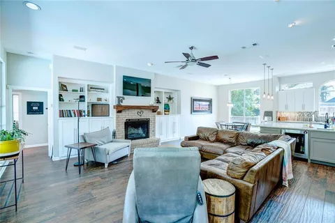 a living room with furniture a fireplace and a flat screen tv
