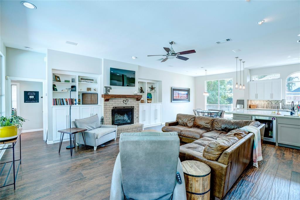 800 Woodcrest Court Southlake, TX 76092 - Photo 14 of 40 a living room with furniture a fireplace and a flat screen tv