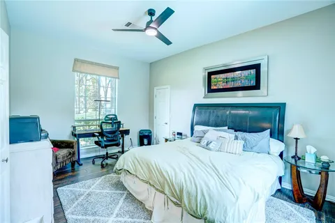 a bedroom with a bed and a desk