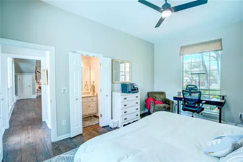 a bed room with a bed and a chair