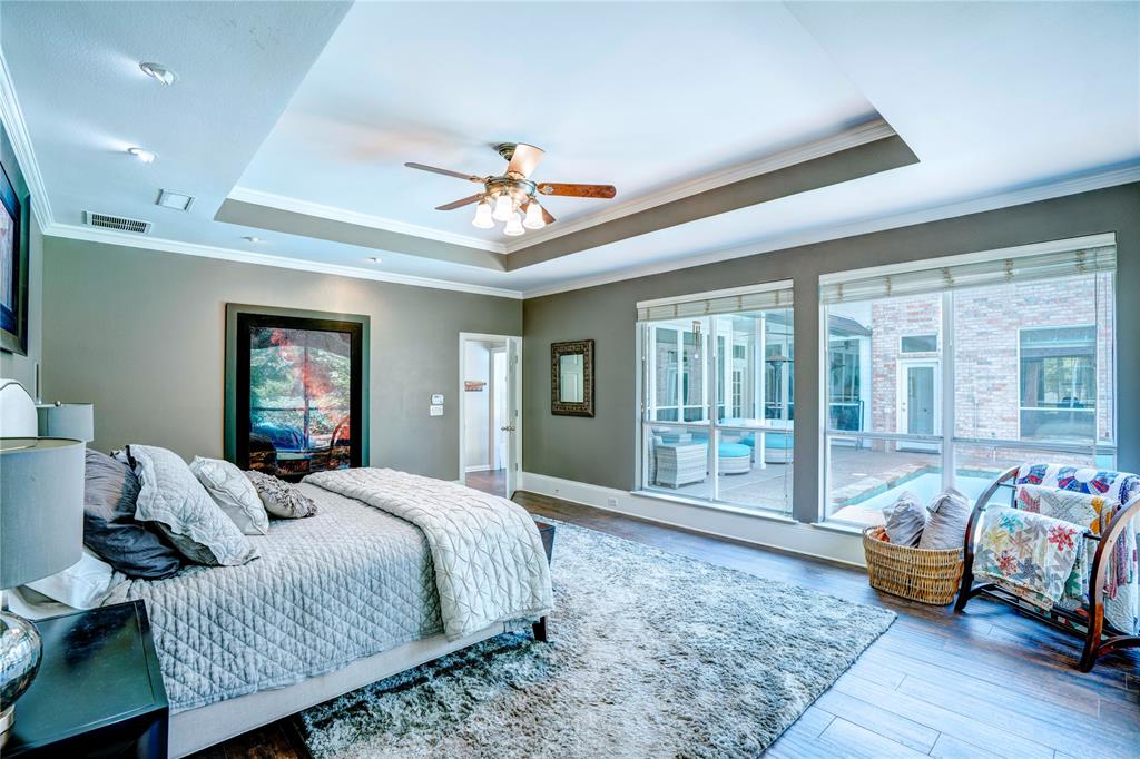 800 Woodcrest Court Southlake, TX 76092 - Photo 23 of 40 a spacious bedroom with a bed and wooden floor