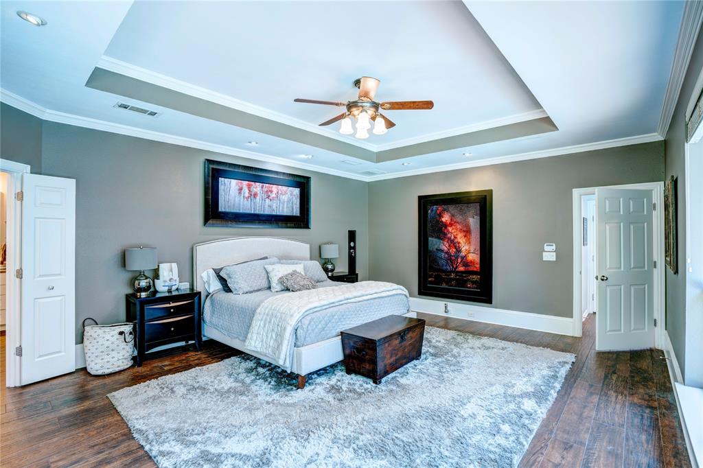 800 Woodcrest Court Southlake, TX 76092 - Photo 24 of 40 a bedroom with a large bed and a chandelier