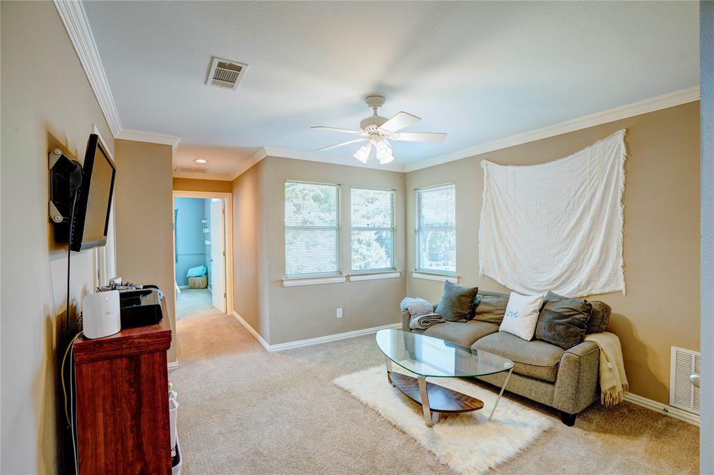 800 Woodcrest Court Southlake, TX 76092 - Photo 27 of 40 a living room with furniture a flat screen tv and a window