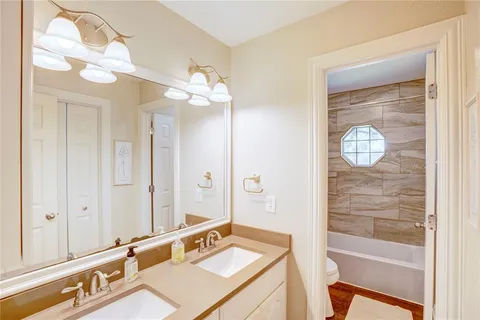 a bathroom with a sink tub and shower