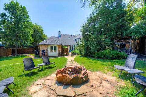 a front view of a house with a yard and furniture
