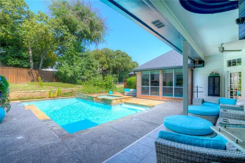 a view of a backyard with swimming pool