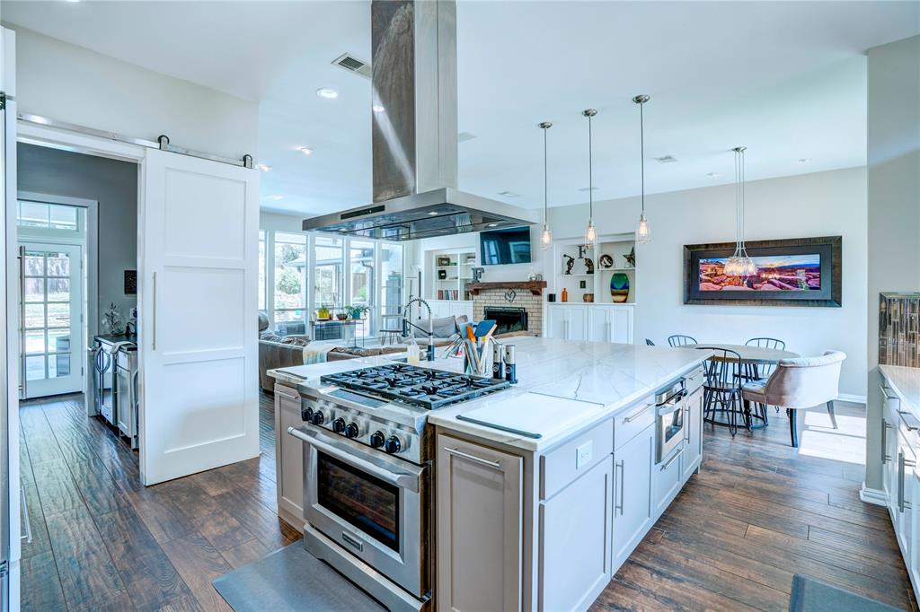 800 Woodcrest Court Southlake, TX 76092 - Photo 7 of 40 a kitchen with stainless steel appliances granite countertop a stove and a wooden floors