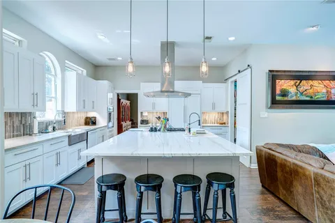 a large kitchen with a table and chairs in it