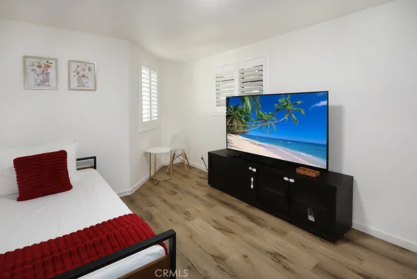 a bedroom with a bed and a painting on the wall