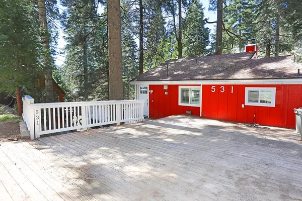 a view of backyard with deck and outdoor space