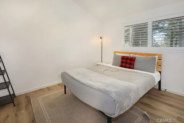 a bedroom with a bed and a mirror