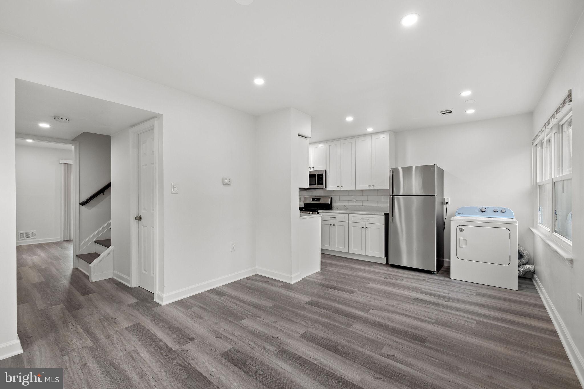 8157 Community Drive Manassas, VA 20109 - Photo 16 of 37 a kitchen with stainless steel appliances a refrigerator and wooden floor