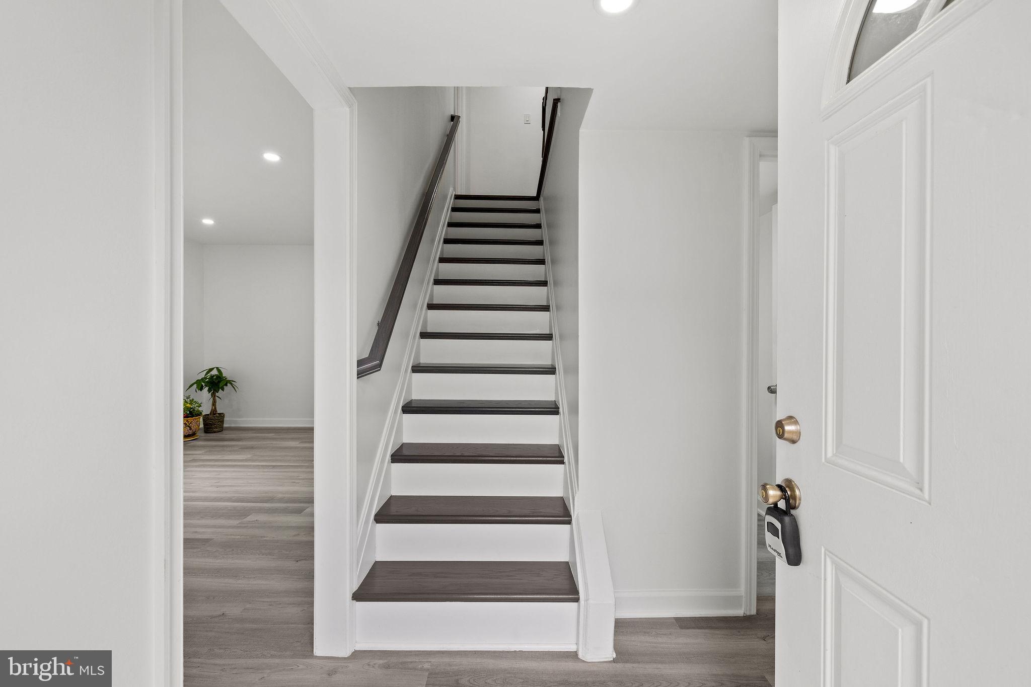 8157 Community Drive Manassas, VA 20109 - Photo 7 of 37 a view of a hallway with wooden floor and entryway