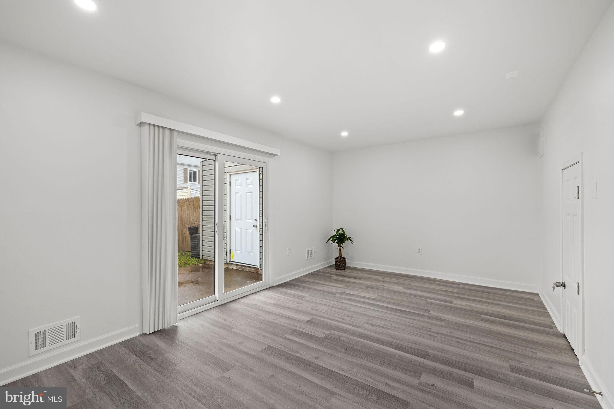 8157 Community Drive Manassas, VA 20109 - Photo 8 of 37 wooden floor in an empty room with a window