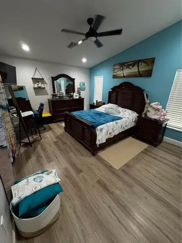 a bedroom with furniture and a mirror