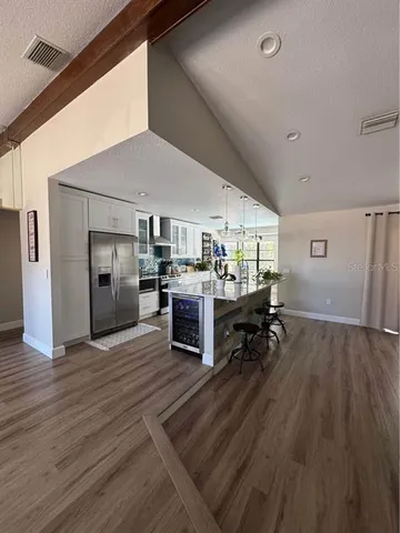 a living room with furniture and kitchen view