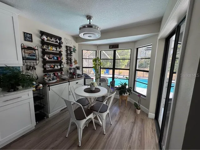 a view of a dining room with furniture window and wooden floor