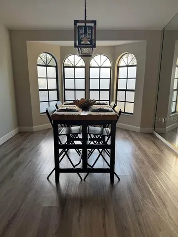a view of a dining room with furniture window and wooden floor