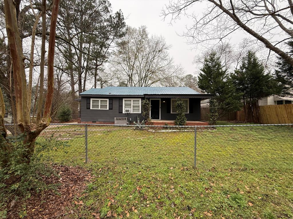 a view of a house with swimming pool and a yard