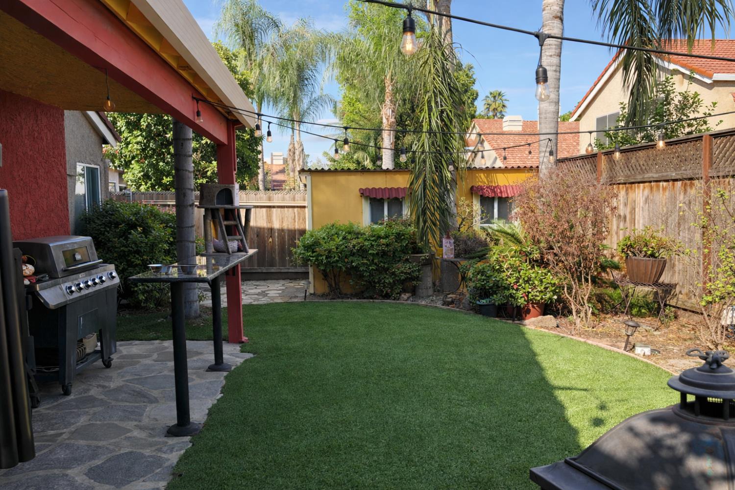 1805 Patton Drive Modesto, CA 95356 - Photo 14 of 15 a view of a backyard with plants potted plants
