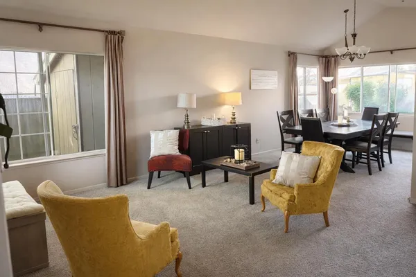 a living room with furniture and a large window