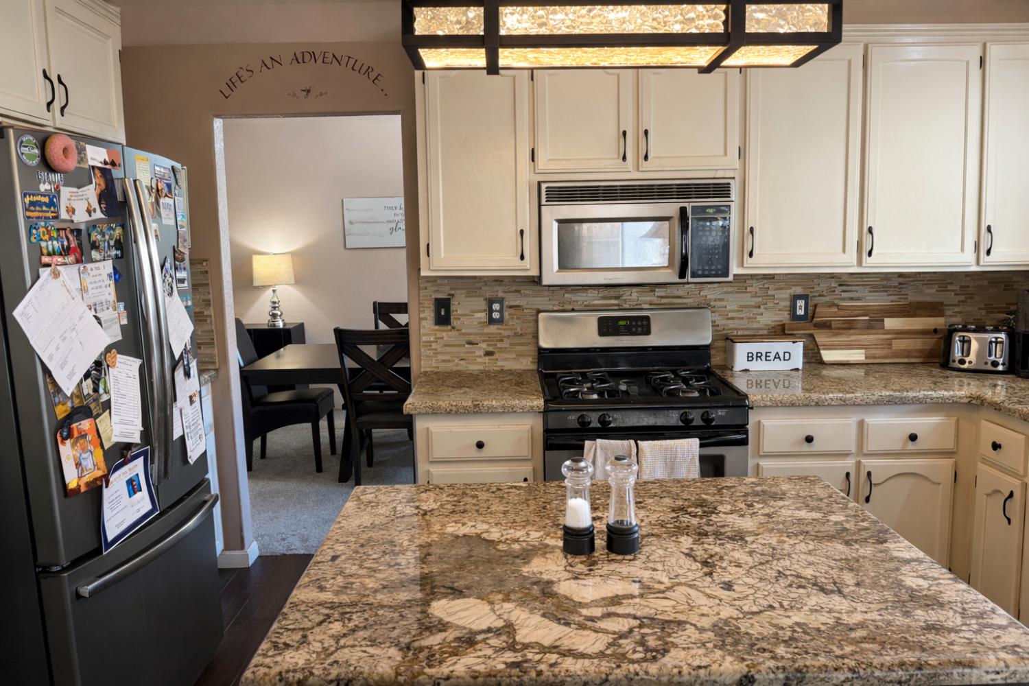 1805 Patton Drive Modesto, CA 95356 - Photo 5 of 15 a kitchen with stainless steel appliances granite countertop a stove a sink a microwave and a refrigerator