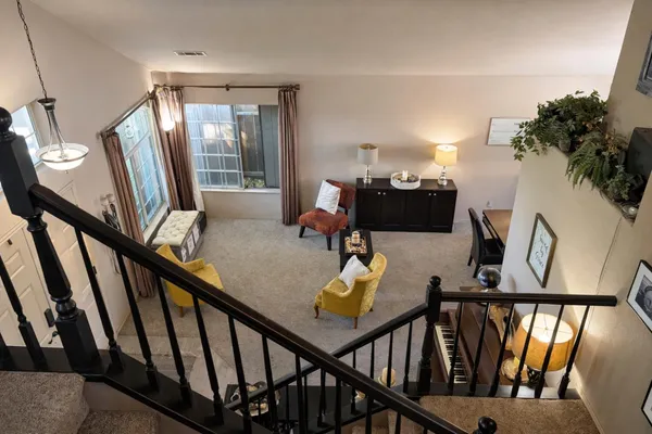 a view of a livingroom with furniture hardwood floor and stairs