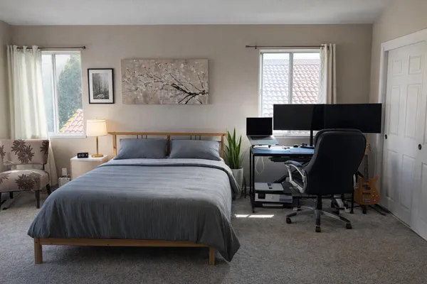 a bedroom with a bed a desk and chair