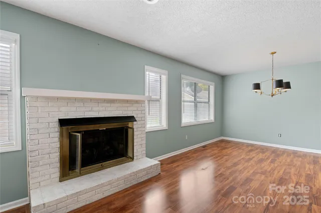 a view of empty room with a fireplace